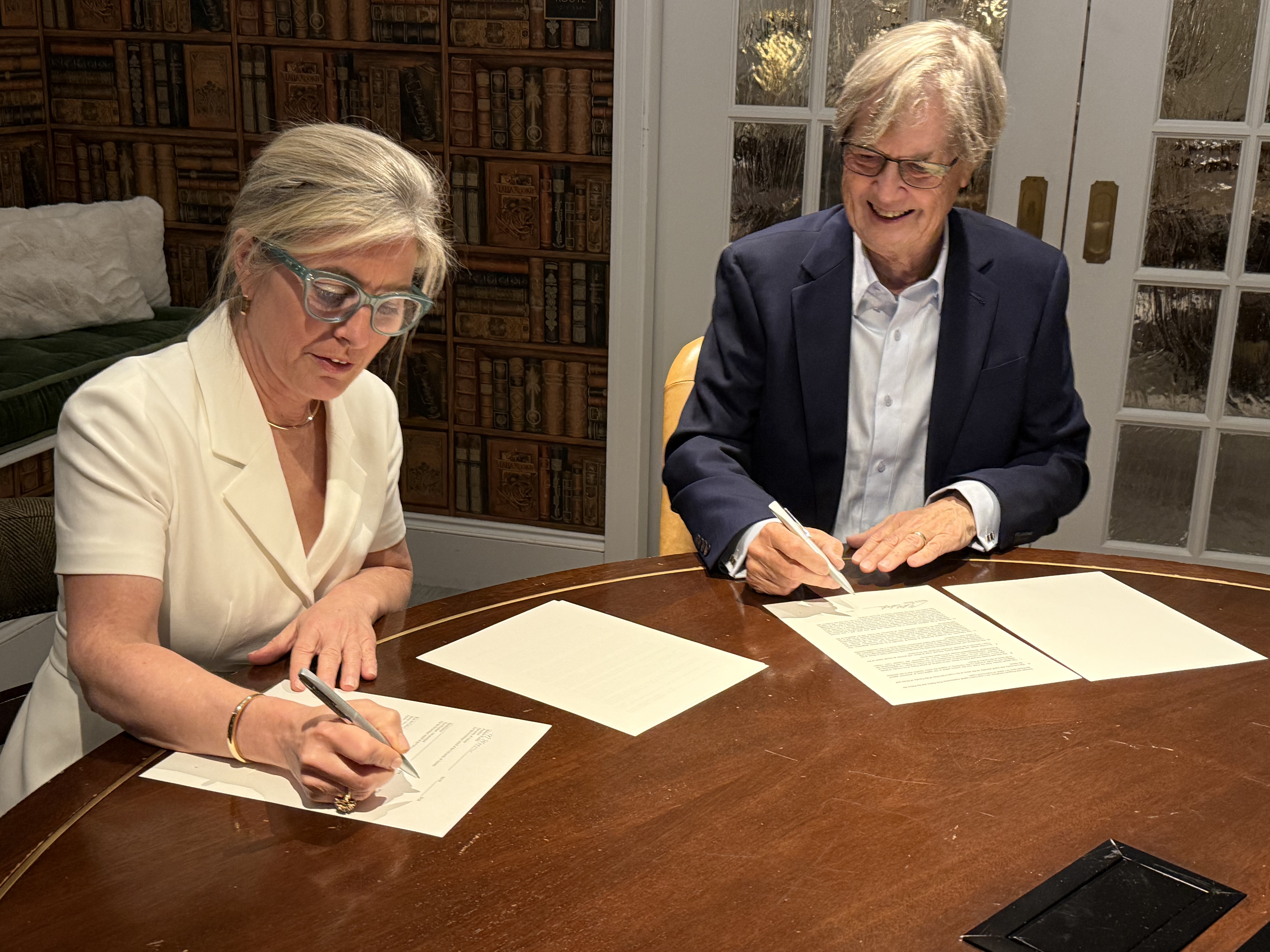 In the photo: U of T President Melanie A. Woodin and Murray R. Metcalfe sign the gift agreement for the Metcalfe Family Decanal Chair in Music.