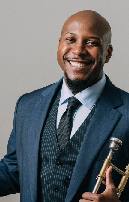 Headshot of Marques Young holding a trombone