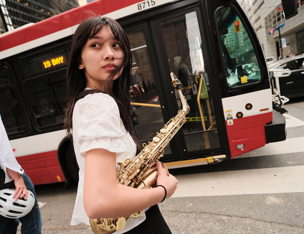 Bea Lagrisola with her alto saxophone in downtown Toronto