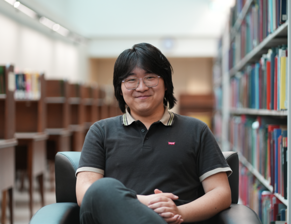 Eric Yang poses for a photo in the U of T Music Library.