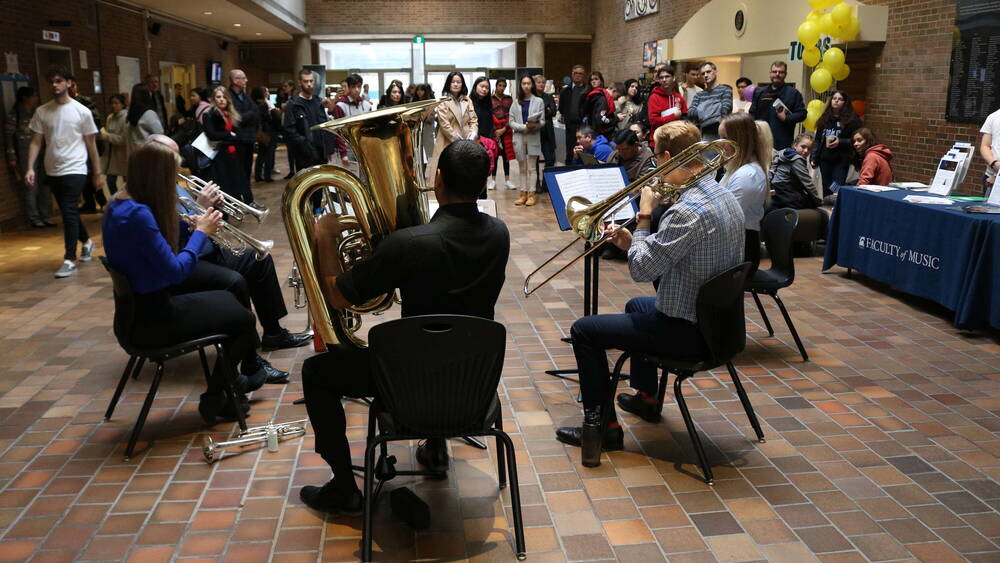 Thumbnail Image for Brass quintet performing for crowd in lobby.