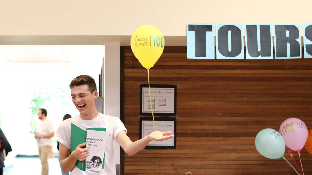 Thumbnail Image for Smiling tour guide holding a balloon