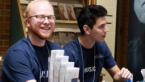 Thumbnail Image for Smiling student at registration table.