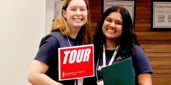 Two smiling tour guides.