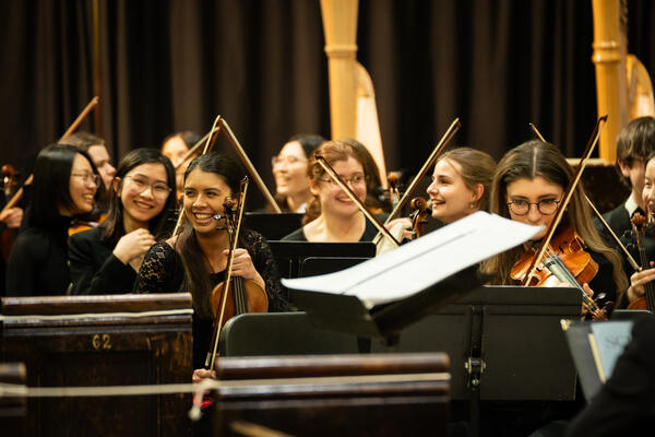 Thumbnail Image for smiling violin players in orchestra
