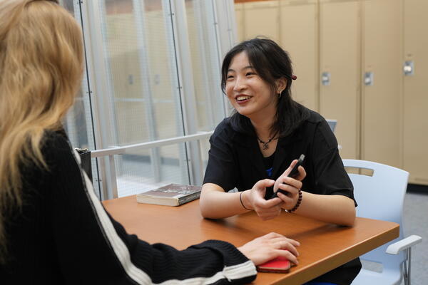 Thumbnail Image for two students talking and smiling