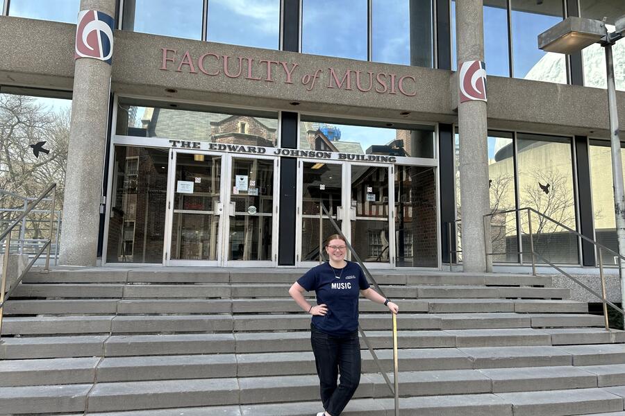 Thumbnail Image for student in front of Music building