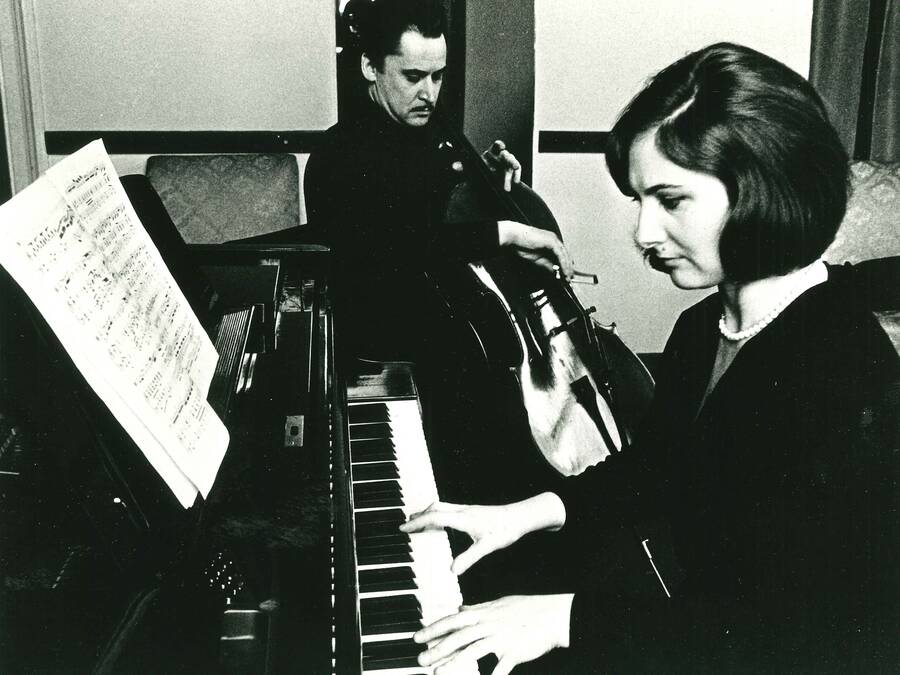 Marietta Orlov playing piano in the foreground, with a cellist in the background