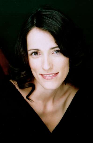 Person wearing a black shirt, smiling and posed for the camera.