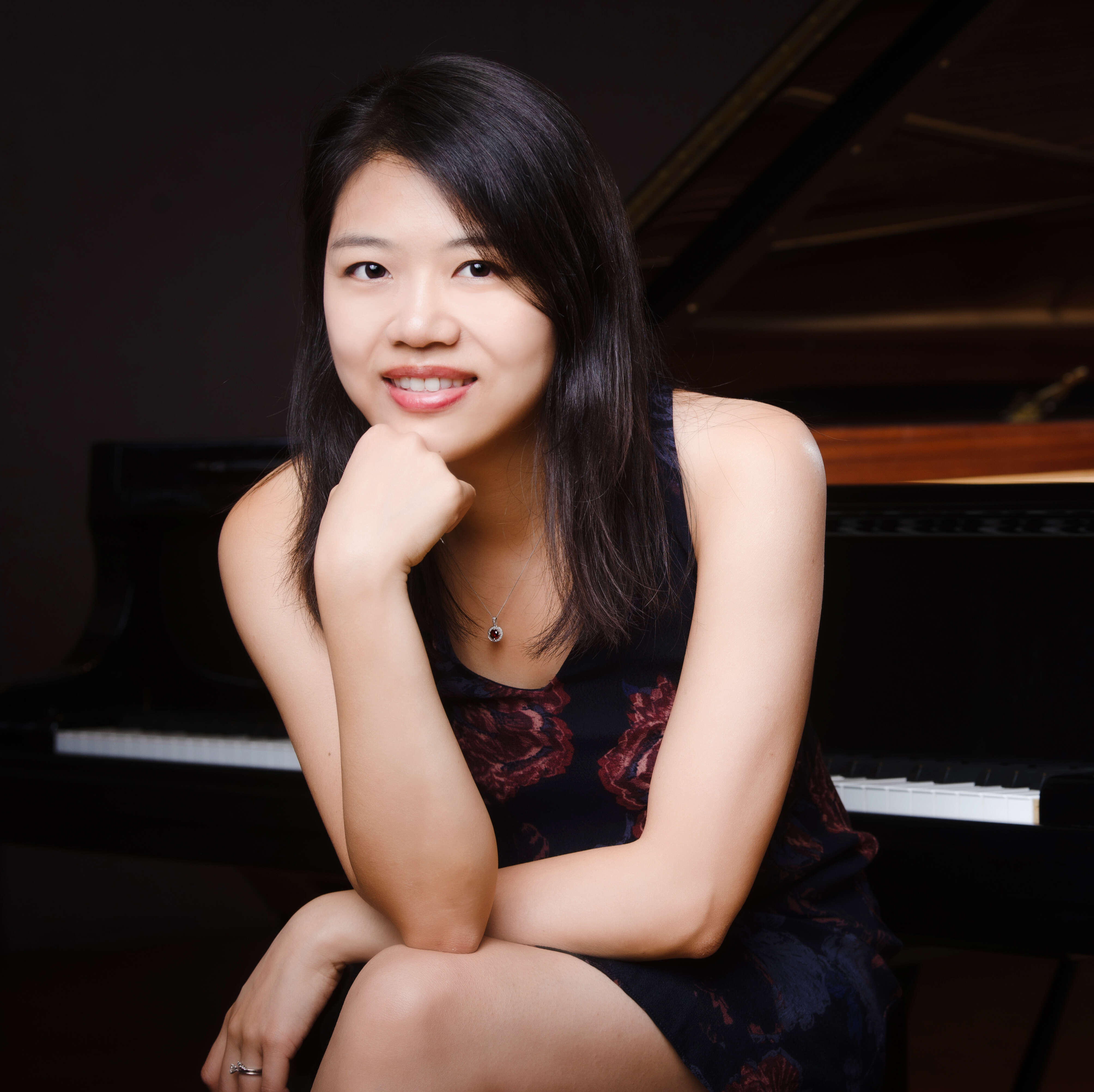 Picture of Pei-Chen Chen sitting in front of a piano