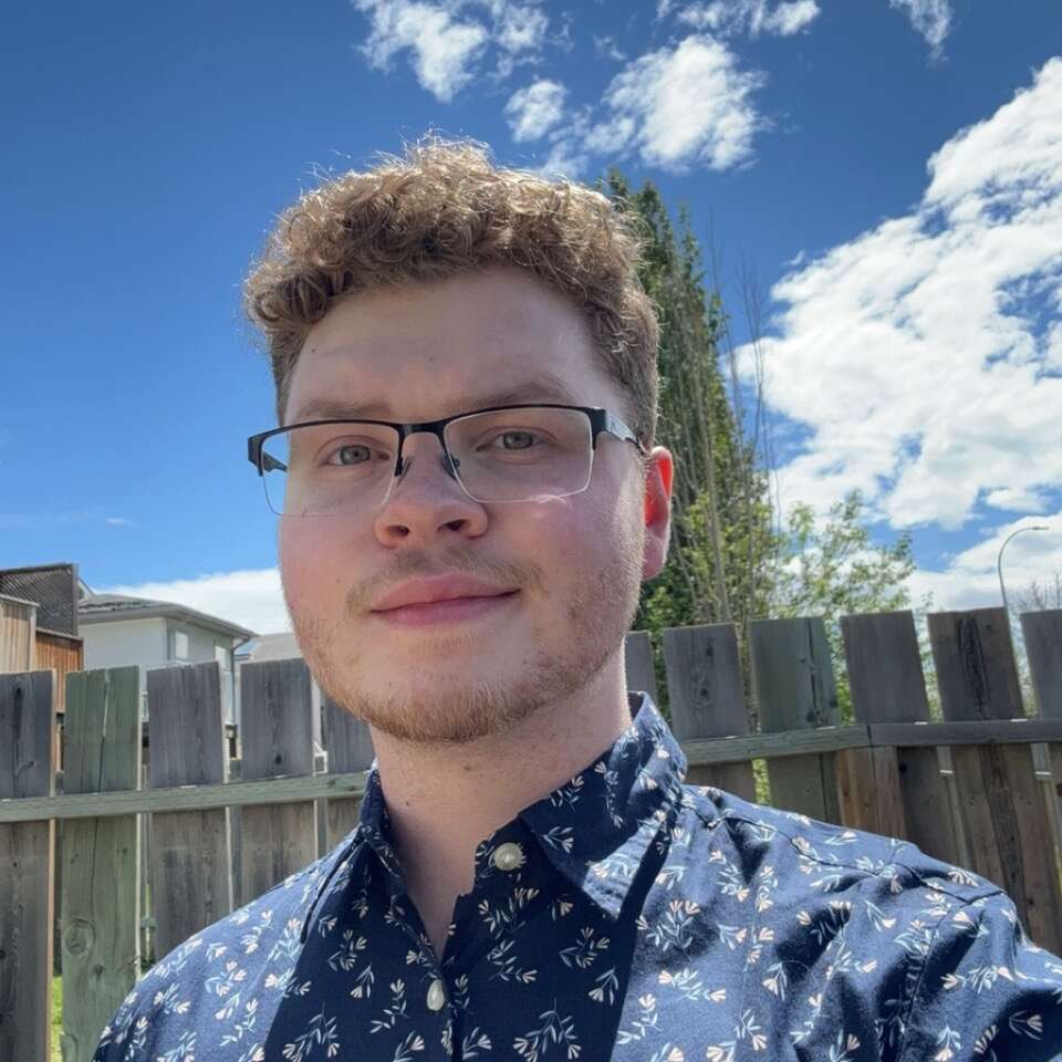 Selfie of person wearing glasses taken in a backyard
