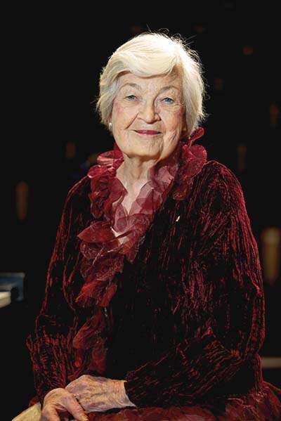 Portrait of older person in a red velvet shirt 