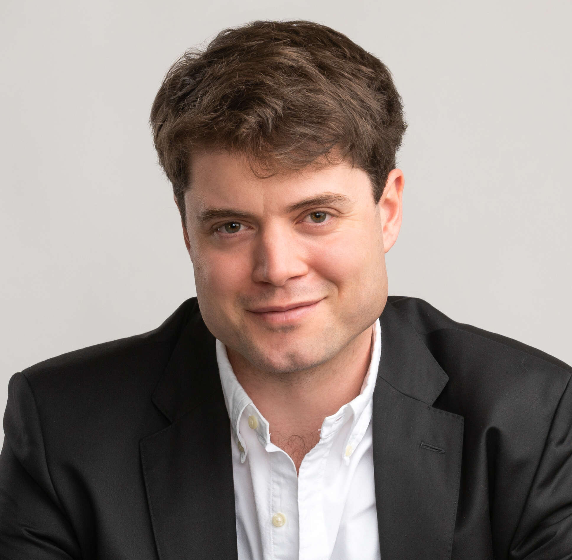 Head shot portrait of Daniel Jordan with grey background