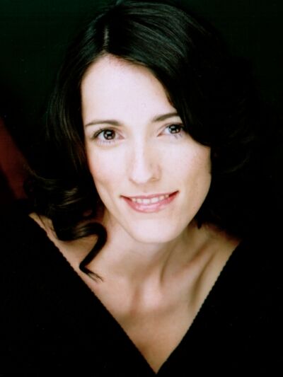 Person wearing a black shirt, smiling and posed for the camera.