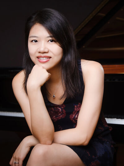 Picture of Pei-Chen Chen sitting in front of a piano