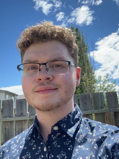 Selfie of person wearing glasses taken in a backyard