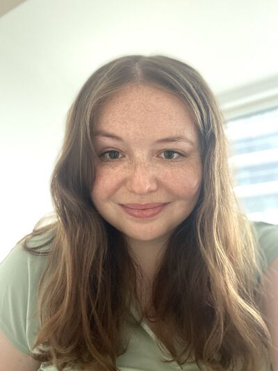 Person with long hair smiling 