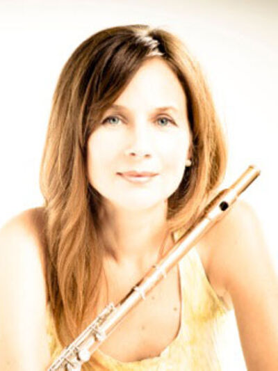 Person wearing a yellow tank top, leaning while holding a flute, exuding a relaxed yet focused vibe.
