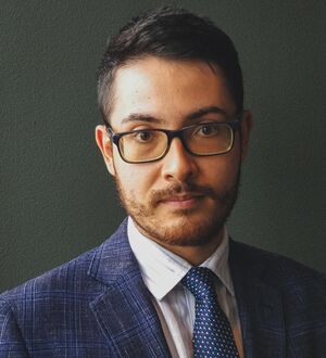 headshot of a person in a suit and tie 