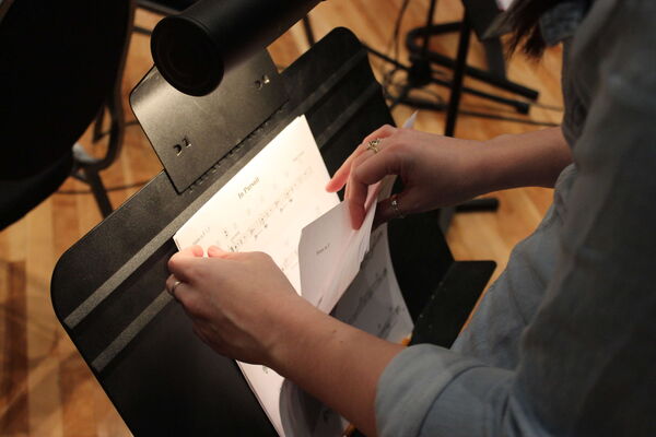 Reviewing sheet music on a stand