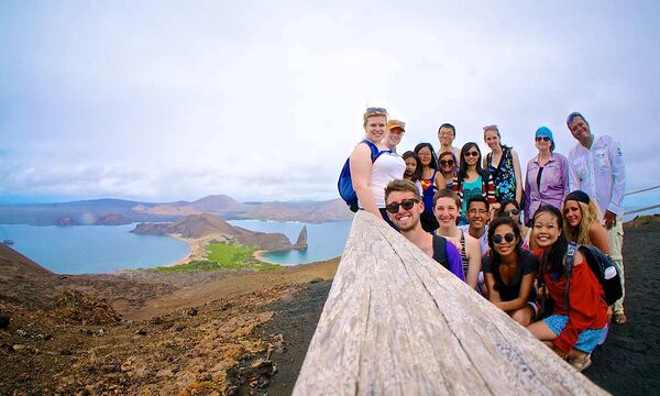 Group of students looking at the came with islands in the background.