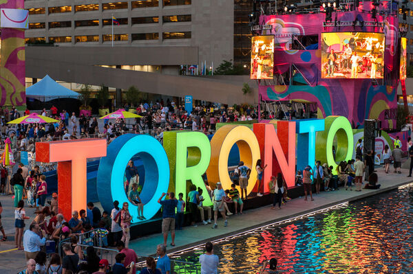 Large multi-colour marquee sign of Toronto in front of City Hall