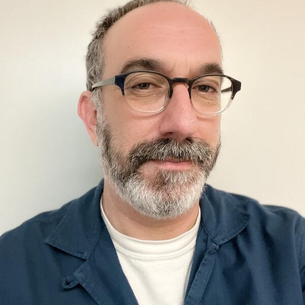 headshot of a person with a beard on a white background
